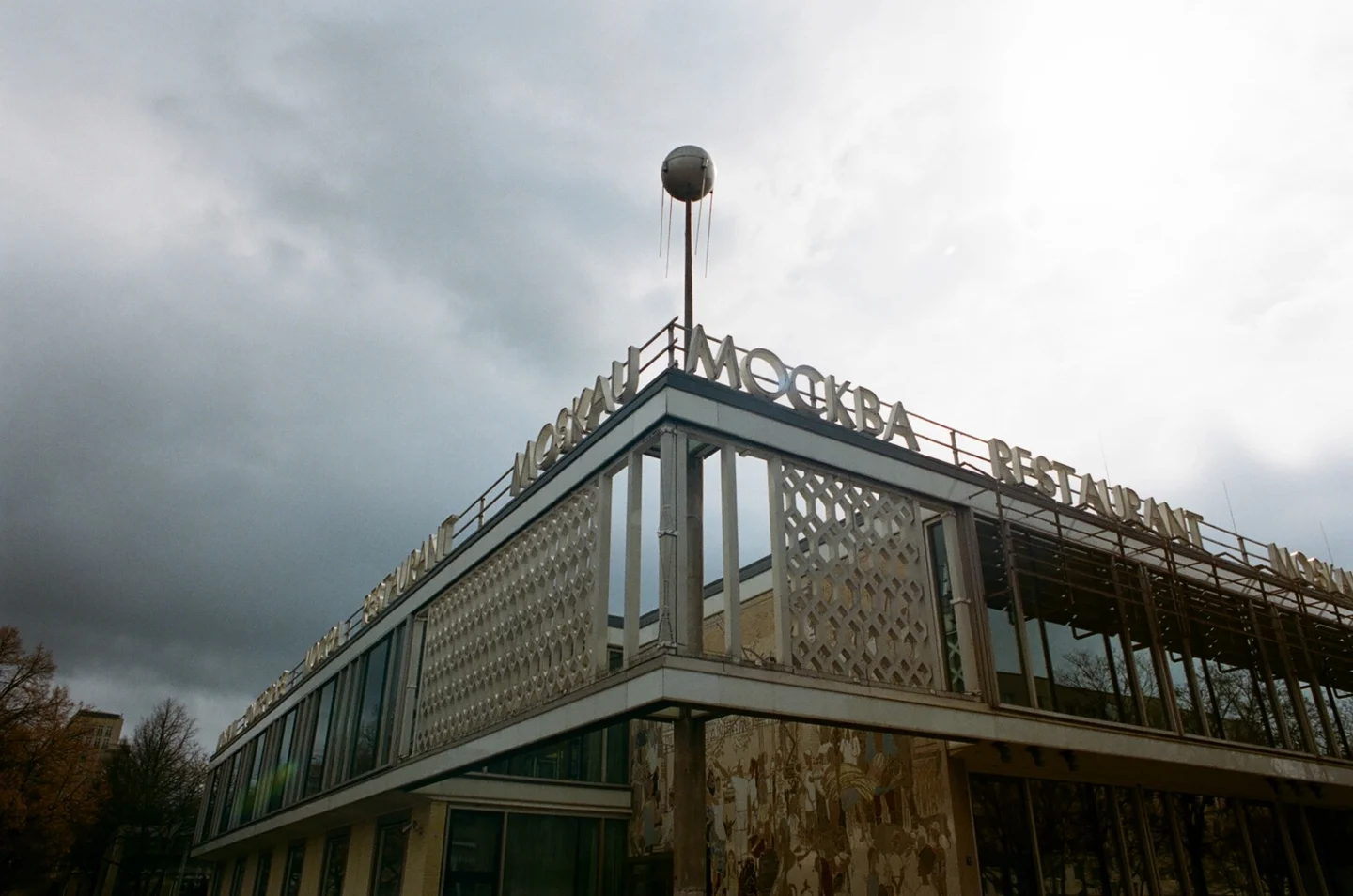 Café Moskau in Berlin beneath a darkening sky